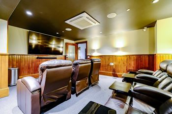 Theater room with recliner seating and large screen tv